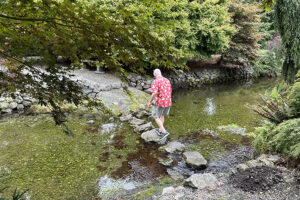 Man on stepping stones over creek